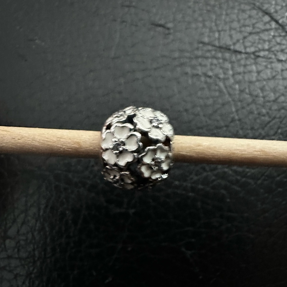 Authentic Pandora “Primrose Meadow” white enamel with clear CZ stones.